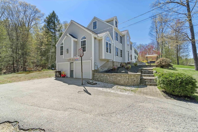 view of side of home featuring an attached garage