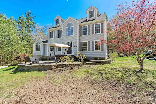 view of front facade with a patio and a front yard