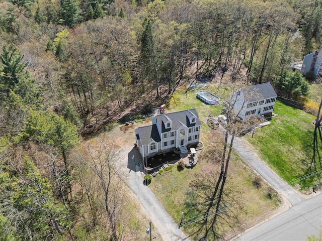 birds eye view of property with a forest view