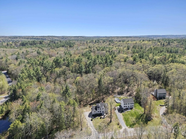 drone / aerial view featuring a wooded view