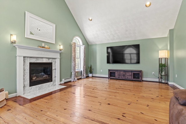 living area featuring a fireplace, baseboards, high vaulted ceiling, hardwood / wood-style flooring, and a baseboard radiator