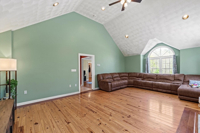 living room with a ceiling fan, recessed lighting, lofted ceiling, and hardwood / wood-style floors