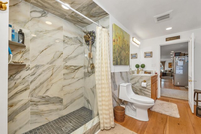 full bathroom featuring toilet, visible vents, a shower stall, and wood finished floors