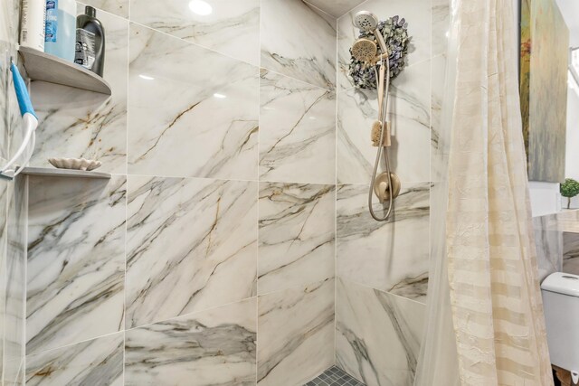 full bathroom with toilet and tiled shower