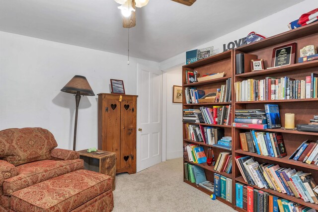 sitting room featuring carpet floors and a ceiling fan