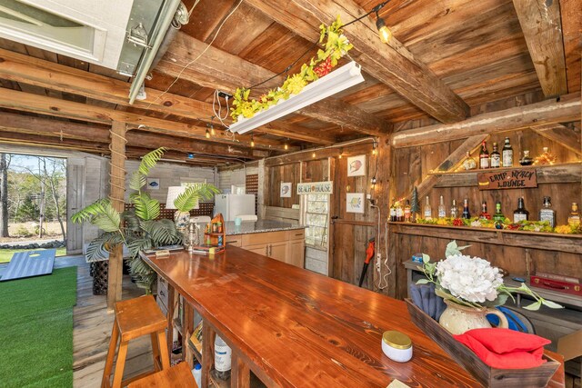 interior space featuring wood finished floors, wooden walls, and wooden ceiling