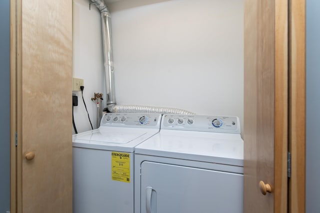laundry room featuring separate washer and dryer and laundry area