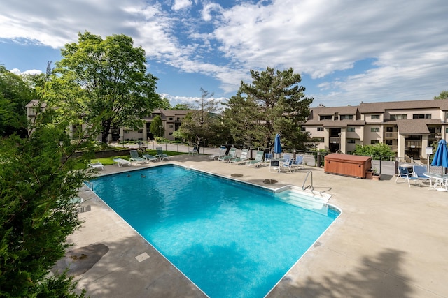 pool featuring a patio area and fence
