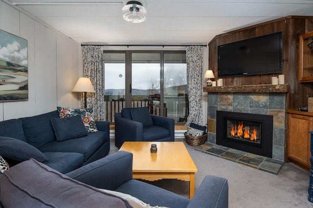 living room featuring a fireplace and carpet