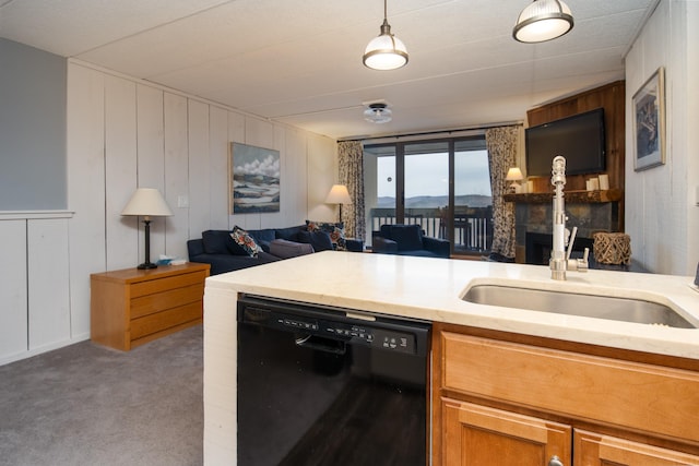 kitchen with a large fireplace, black dishwasher, carpet floors, open floor plan, and a decorative wall