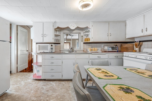 kitchen featuring open shelves, a sink, light countertops, white appliances, and white cabinetry