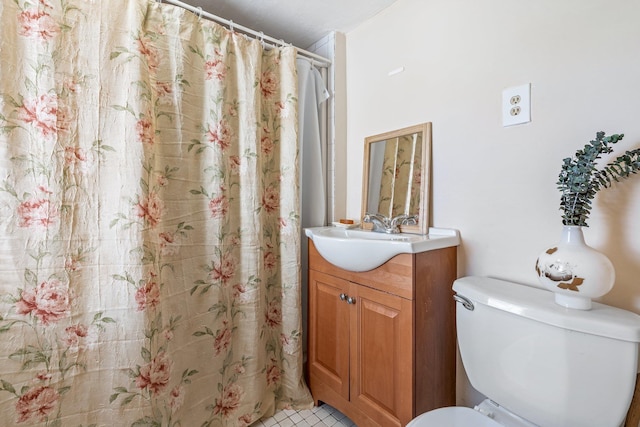 bathroom with vanity, tile patterned flooring, toilet, and curtained shower