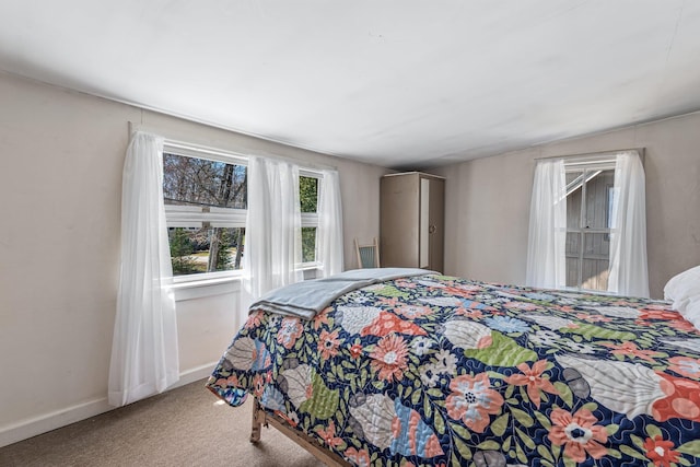 carpeted bedroom with baseboards