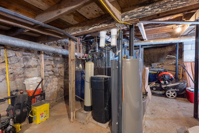 unfinished basement featuring gas water heater