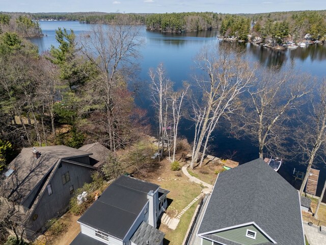 aerial view with a water view and a forest view