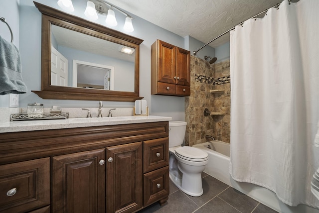 bathroom featuring tile patterned flooring, shower / bath combo with shower curtain, vanity, toilet, and a textured ceiling