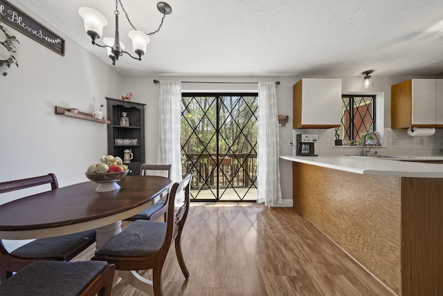 dining room featuring wood finished floors and a chandelier