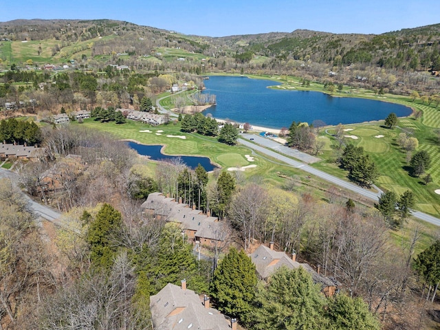 drone / aerial view with view of golf course and a water and mountain view