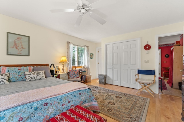 bedroom with a closet, ceiling fan, and light wood-style floors
