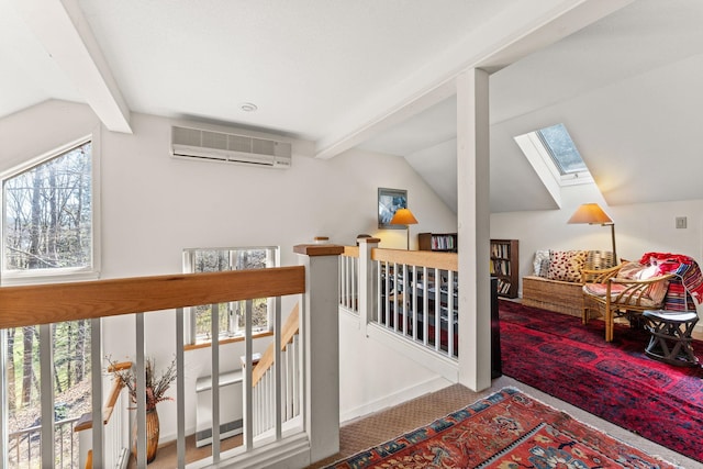 bonus room featuring carpet flooring, a wall unit AC, lofted ceiling with skylight, and plenty of natural light