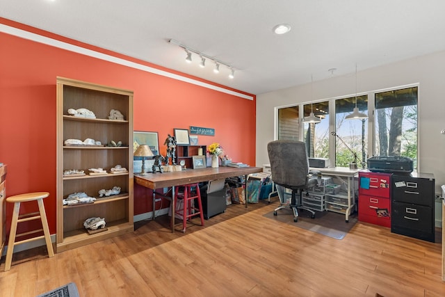 home office featuring track lighting and wood finished floors