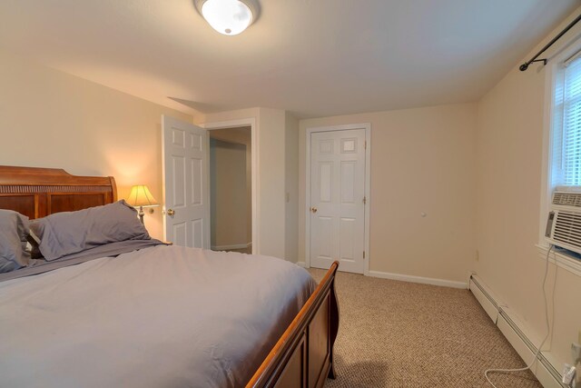 bedroom with baseboards, light colored carpet, and a baseboard radiator