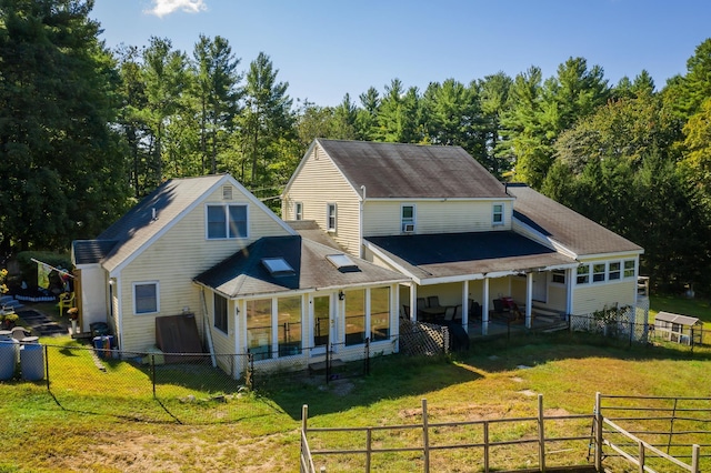 back of house with a yard and a fenced backyard