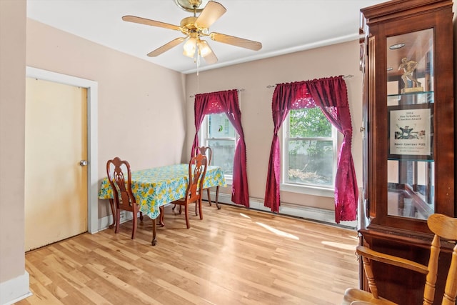 dining space with ceiling fan and wood finished floors