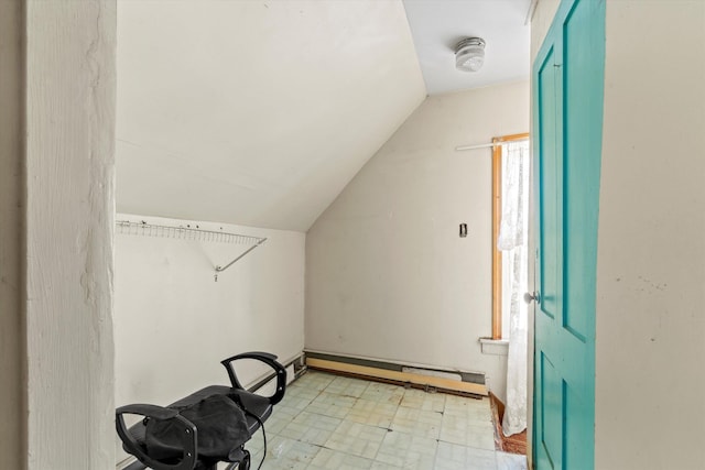 interior space featuring a baseboard radiator, light floors, and lofted ceiling