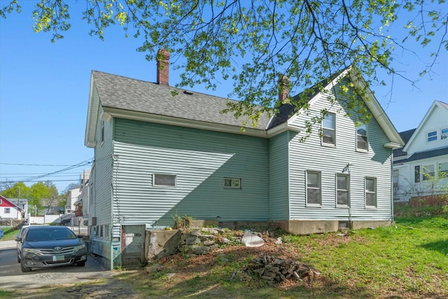 back of property featuring a chimney
