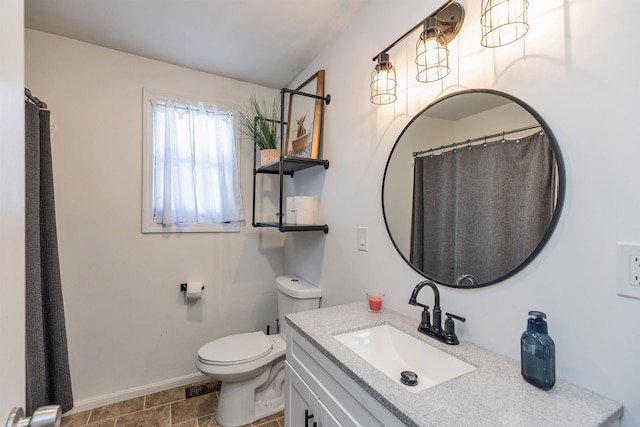 full bathroom featuring vanity, baseboards, and toilet