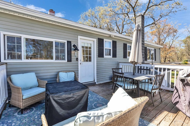 wooden deck featuring outdoor dining space