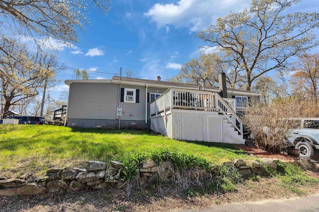 back of property with stairs, a chimney, and a deck