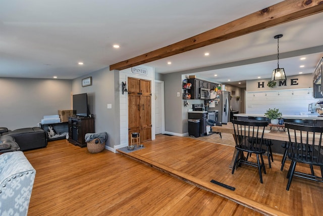 dining space featuring visible vents, baseboards, beamed ceiling, light wood-style floors, and recessed lighting