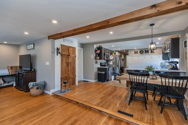 dining area featuring recessed lighting, beamed ceiling, baseboards, and light wood-style floors