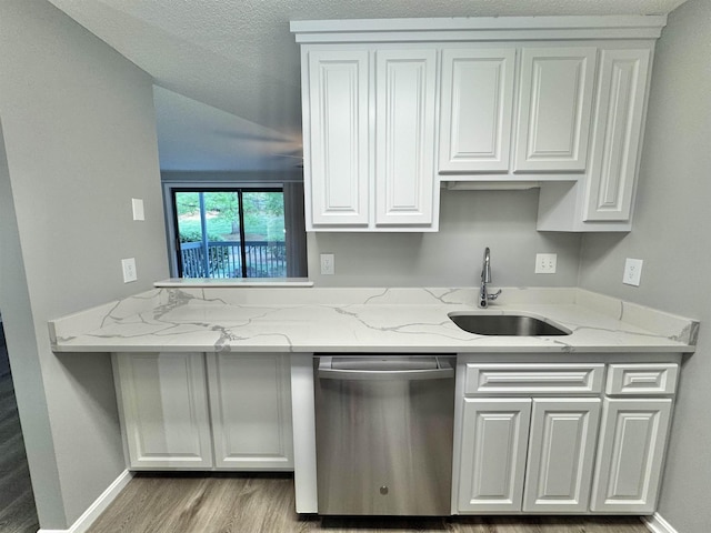 kitchen with white cabinets, wood finished floors, a sink, and dishwasher