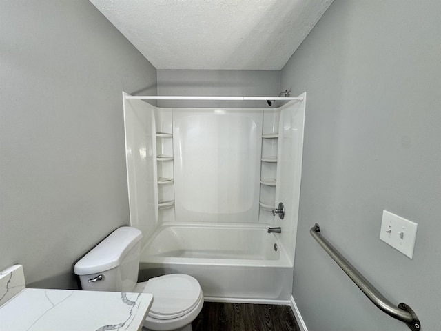 full bathroom with wood finished floors, toilet, baseboards, a textured ceiling, and shower / bathing tub combination