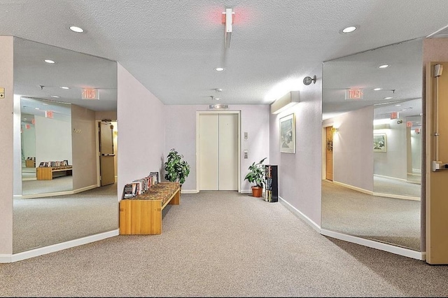 corridor featuring carpet floors, elevator, a textured ceiling, recessed lighting, and baseboards