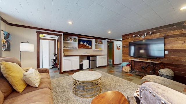 living area with recessed lighting, wood walls, and ornamental molding