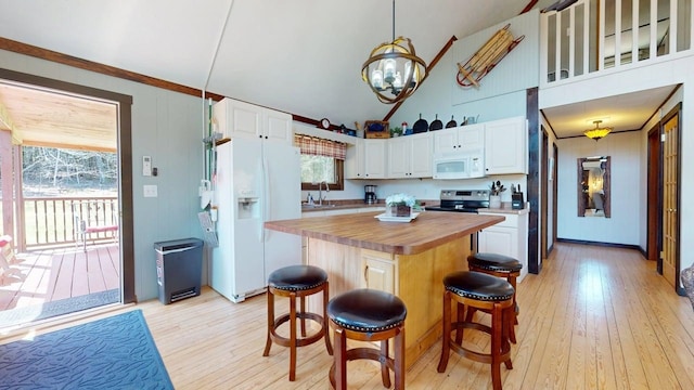 kitchen with an inviting chandelier, white appliances, wooden counters, light wood-style flooring, and white cabinetry