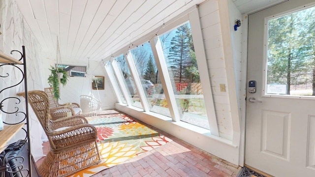 sunroom / solarium featuring wood ceiling and brick patterned floor