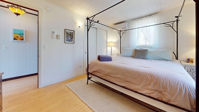 bedroom featuring baseboards and wood finished floors