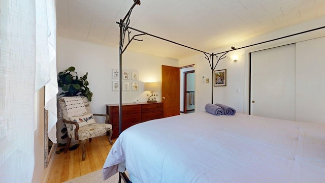 bedroom with a closet and wood finished floors