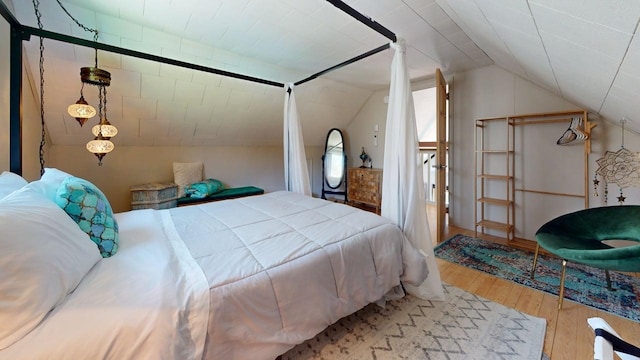 bedroom featuring lofted ceiling and wood finished floors