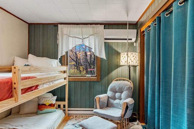bedroom with baseboard heating, an inviting chandelier, a wall unit AC, and wooden walls
