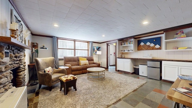 living area with crown molding and a fireplace