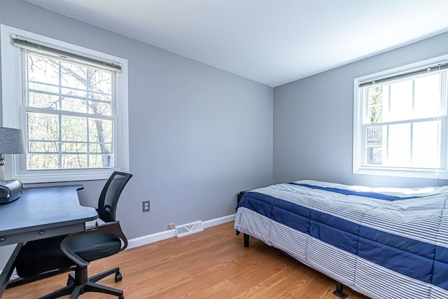 bedroom featuring light wood-type flooring and baseboards