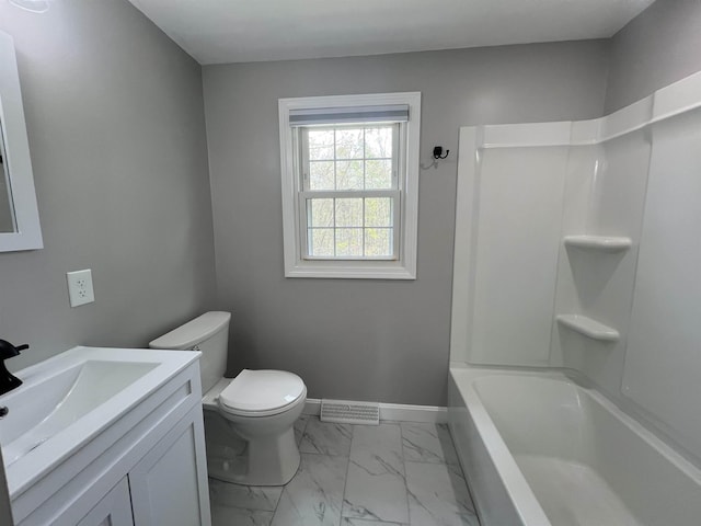 full bathroom with vanity, toilet, marble finish floor, baseboards, and  shower combination
