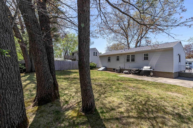 rear view of house with a lawn, cooling unit, fence, and a patio