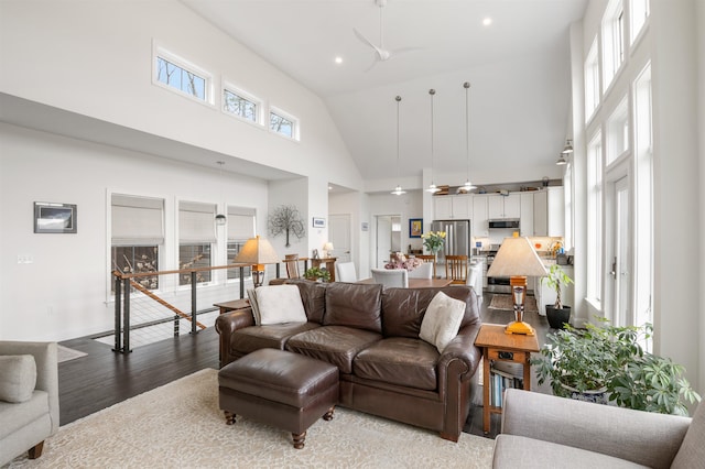 living room featuring high vaulted ceiling, ceiling fan, recessed lighting, and wood finished floors